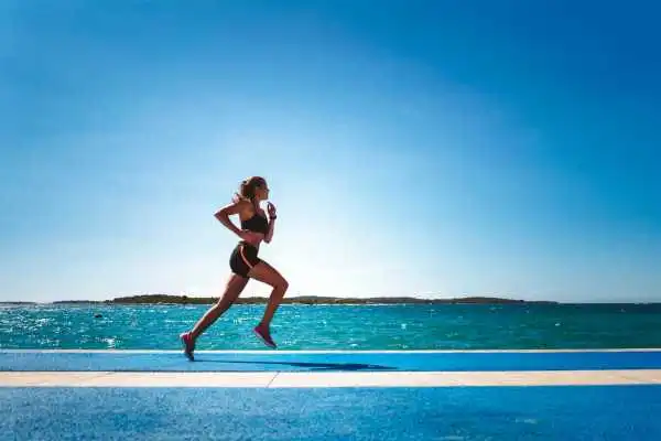 Woman running showing strong leg muscle Blackpool